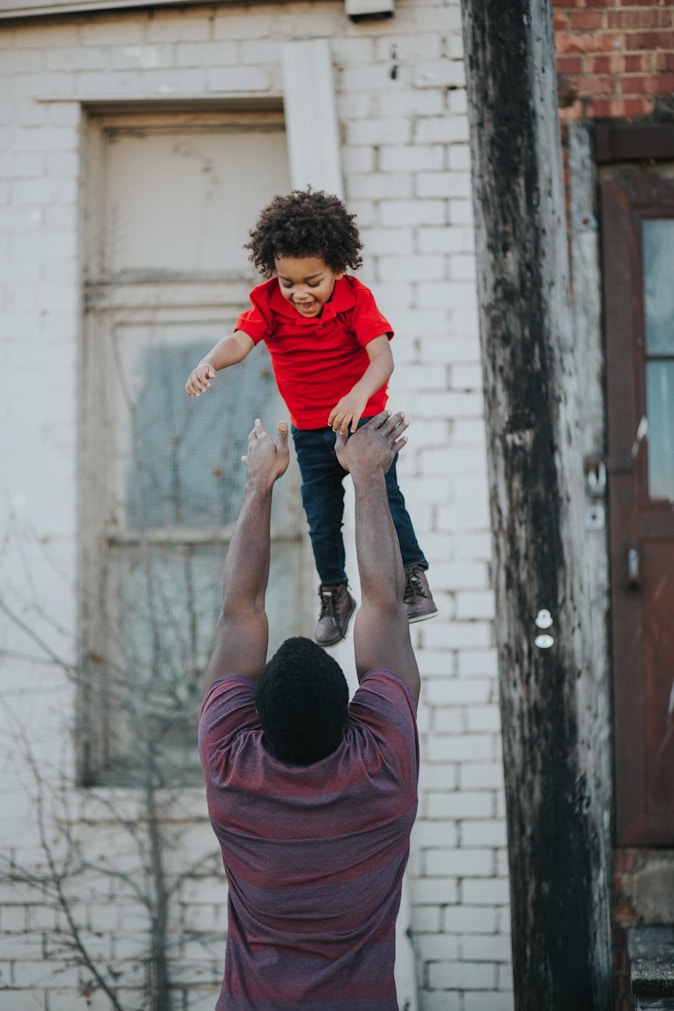 Parent lifting child in the air